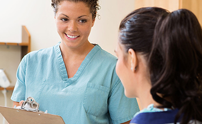 female medical assistant talking to a patient