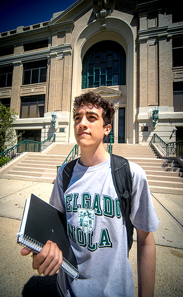 Student looking up in front of building 1