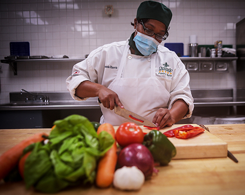 culinary student cutting vegetables