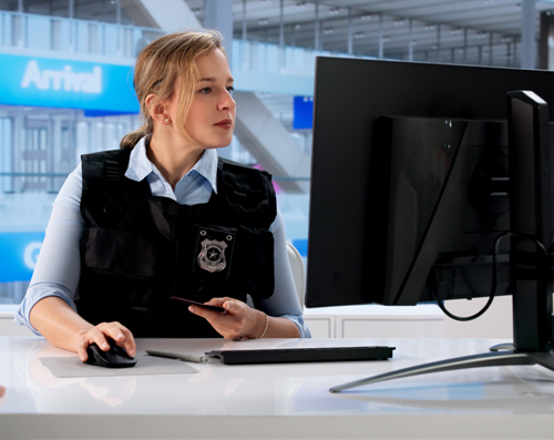 female security officer checking credentials at an airport
