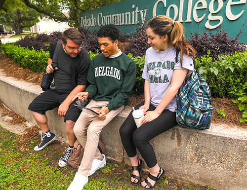 group of students in front of Delgado sign