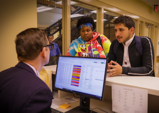 delgado employee helping a student