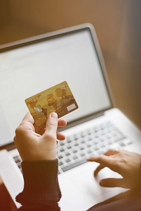A woman makes an online payment via credit card.