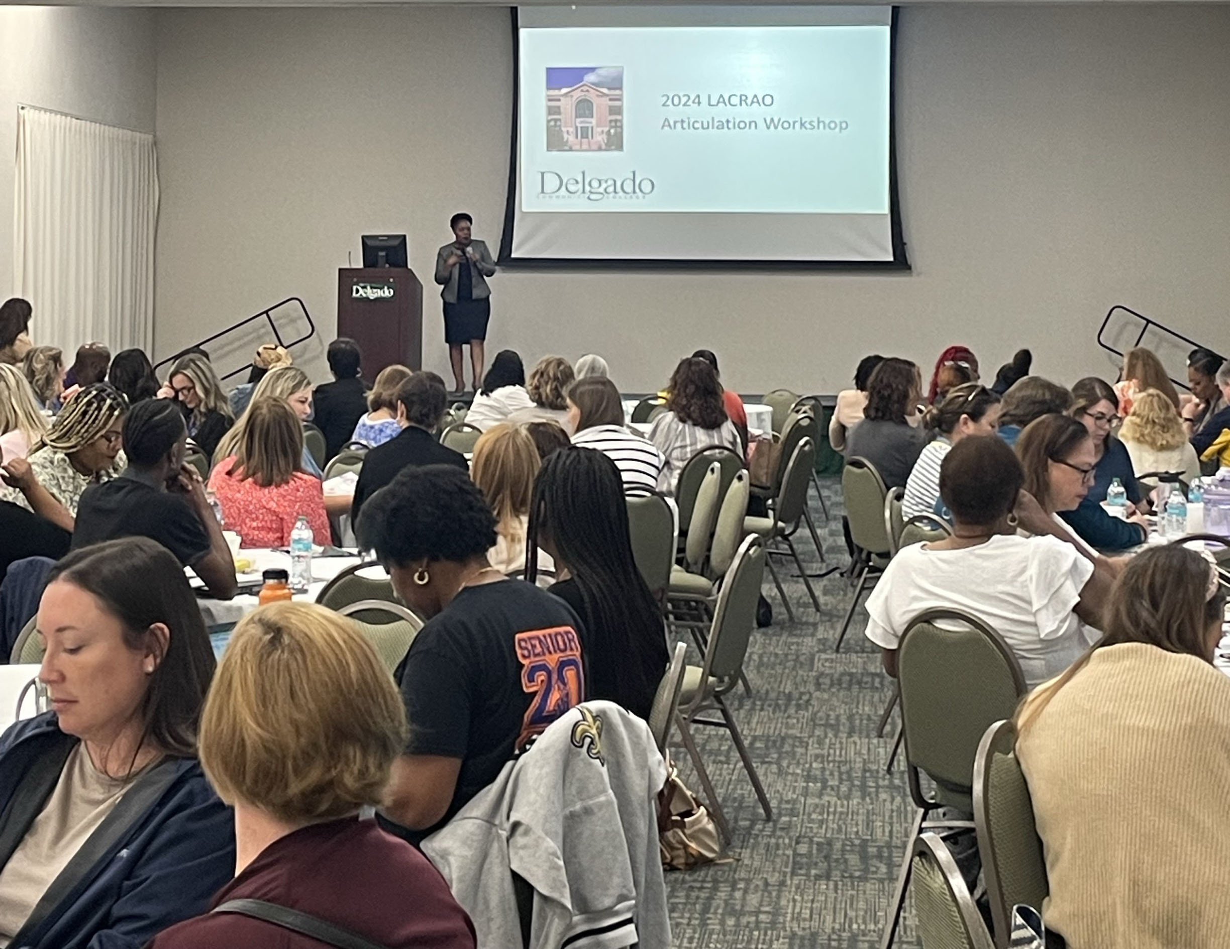 Conference attendees watch Dr. Tamika Duplessis make her presentation