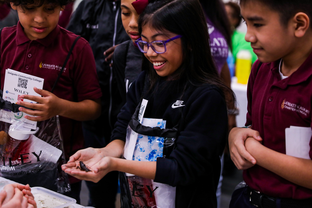 A girl holds a crawfish
