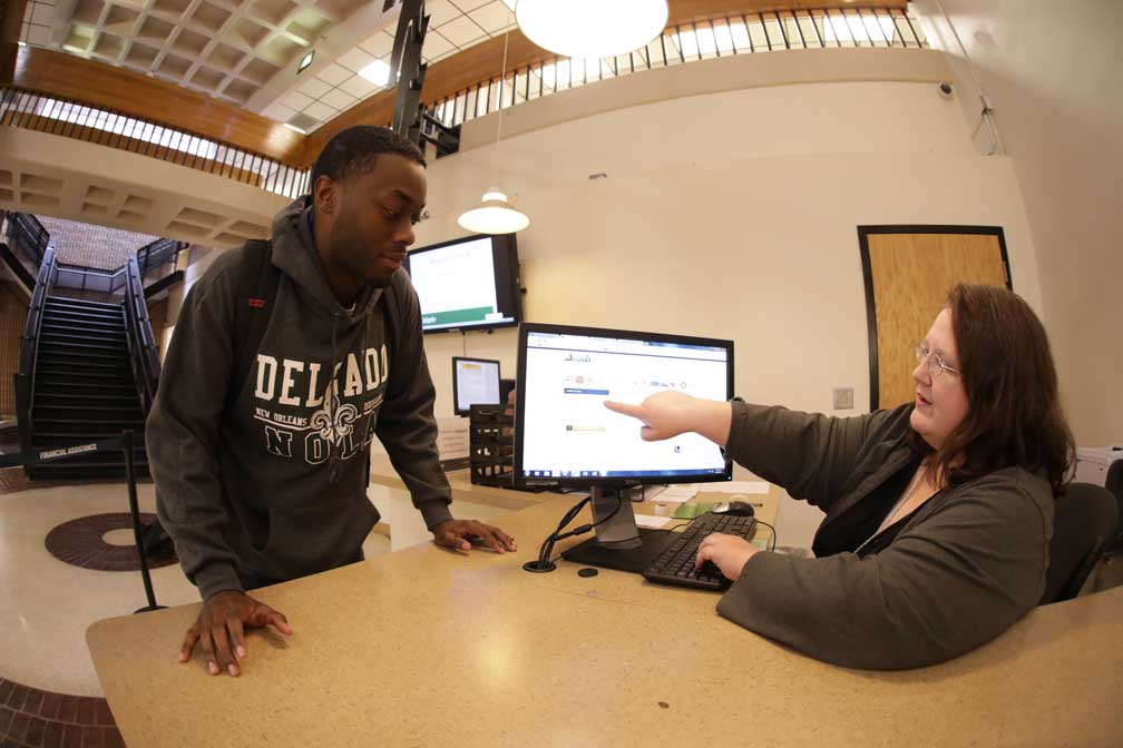A Delgado student is helped at the Answer Center welcome desk on the City Park Campus.
