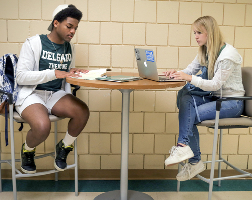 female & male student sitting at a table